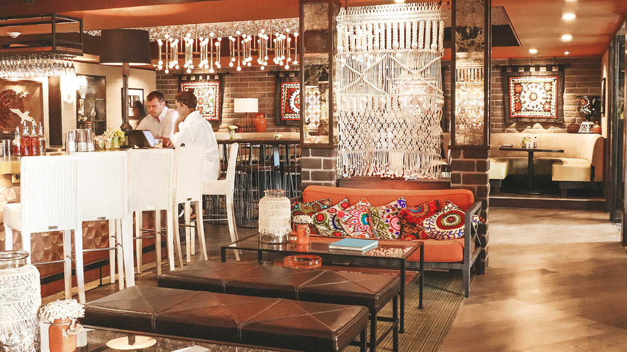 Guests at indoor bar with recessed mood lighting