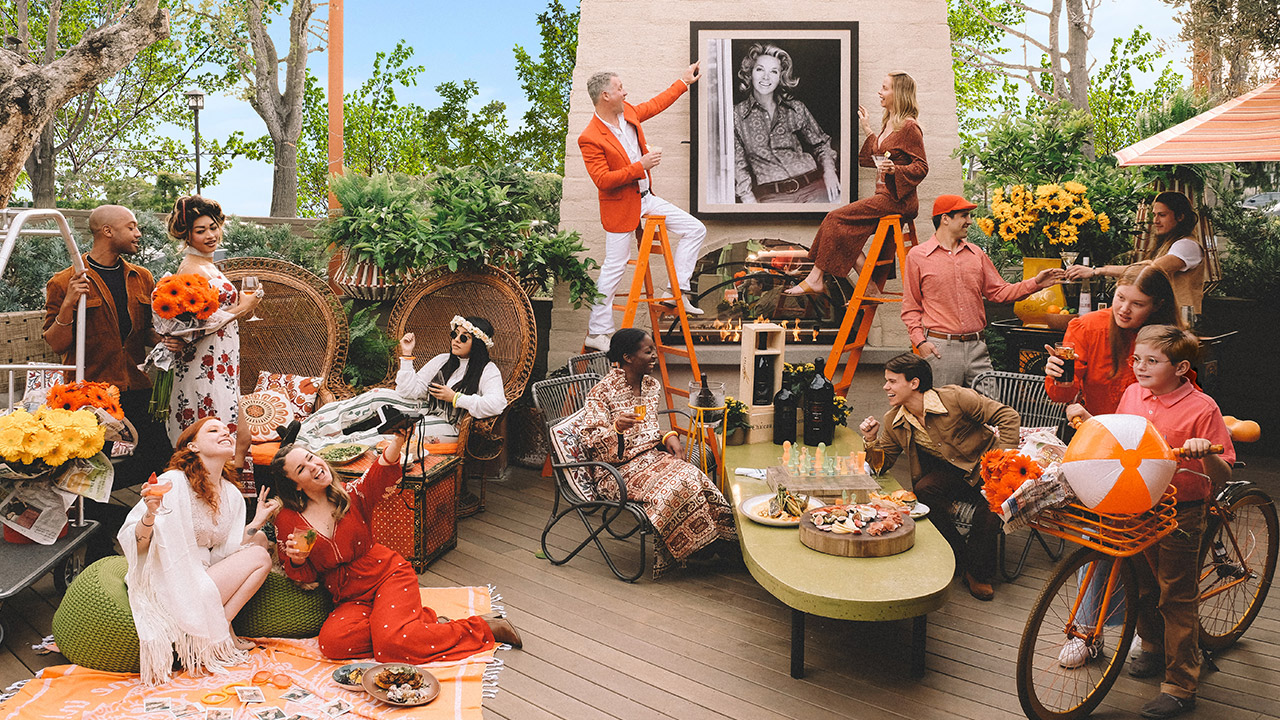 Guests at fall-themed party with orange accents throughout